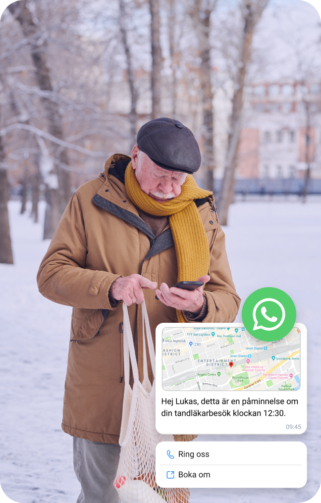 Äldre man i snön kollar sin mobil för plats via WhatsApp Business meddelande